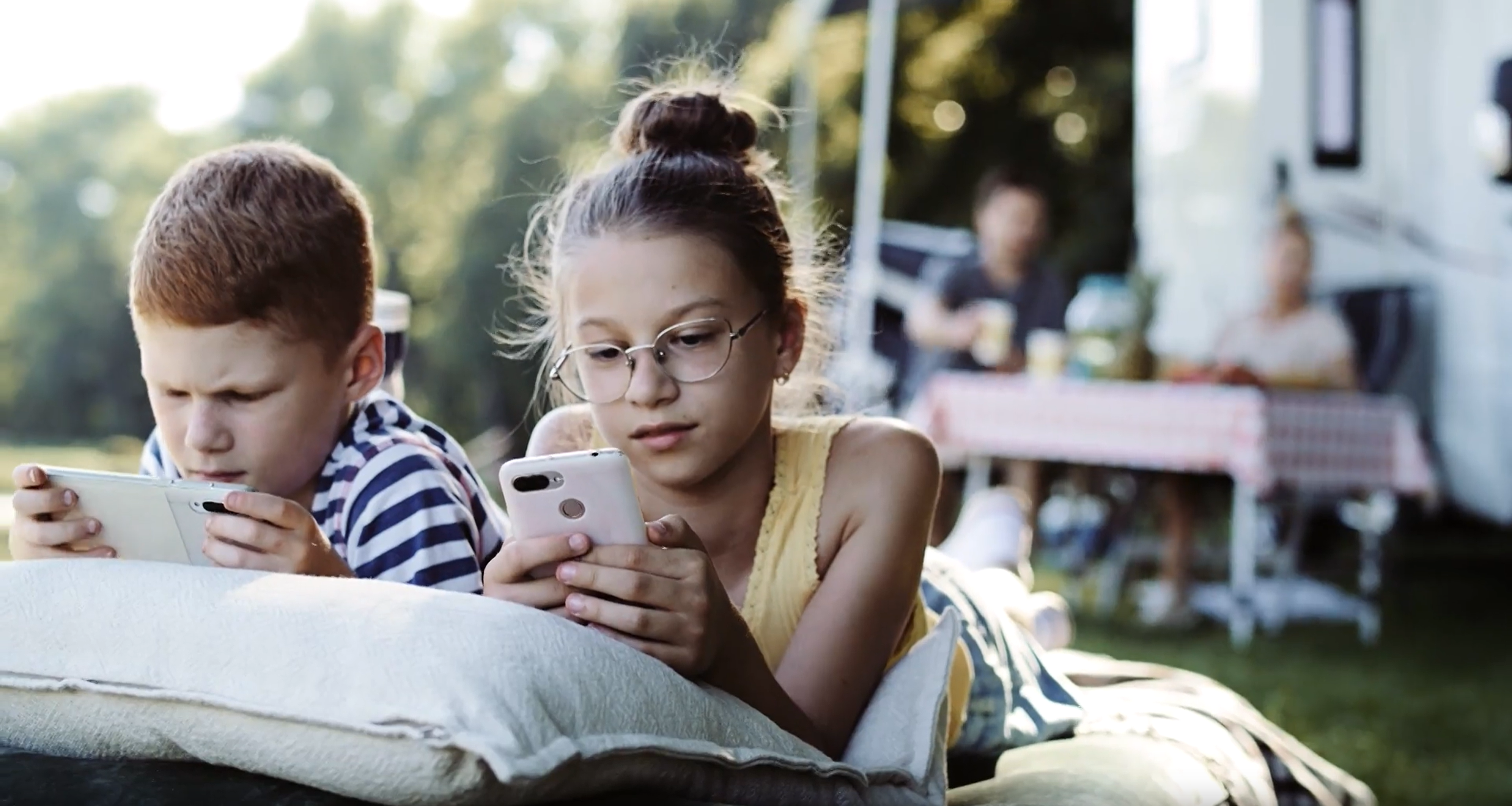 Children at the campsite with their smartphones